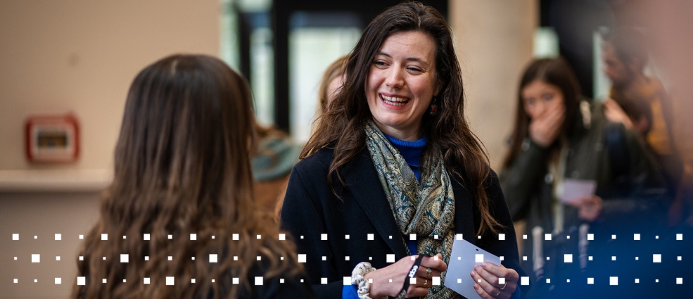 A participant at an ECPR event collecting a registration badge