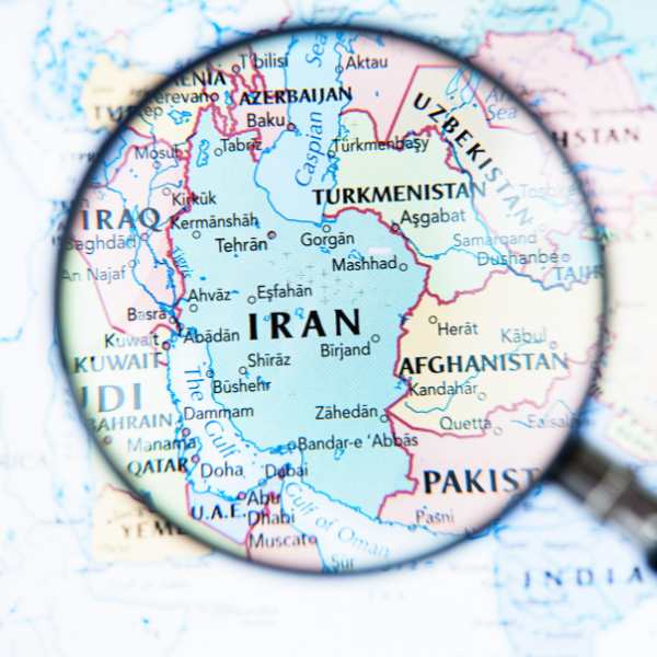 Colourful map of the Middle Eastern region with a magnifying glass zoomed in on Iran