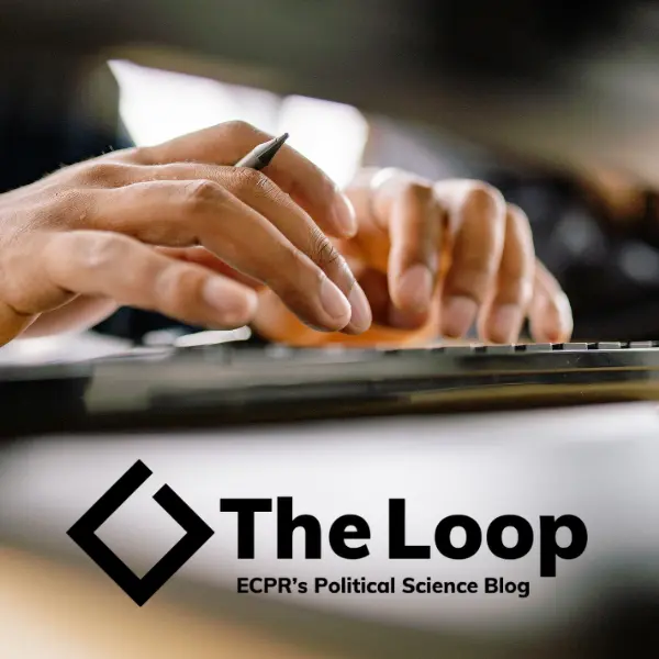 Close-up of hands typing on a keyboard with a pen in one hand. The Loop